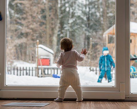 Exterior Cleaning — Toddler Standing and Leaning Against a Window in Gibsonia, PA