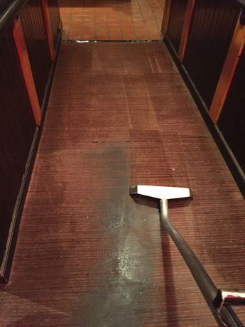 Woman cleaning carpet with brush