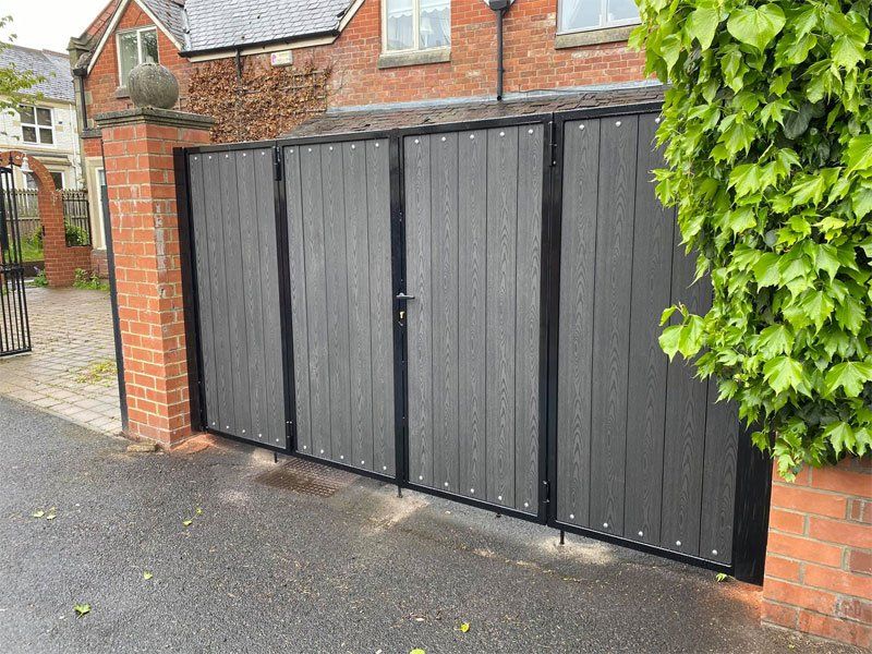 Bifolding gates fitted with charcoal black composite boards
