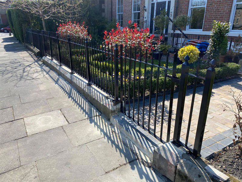 New victorian style railing and gate on top of the old stand stone coping