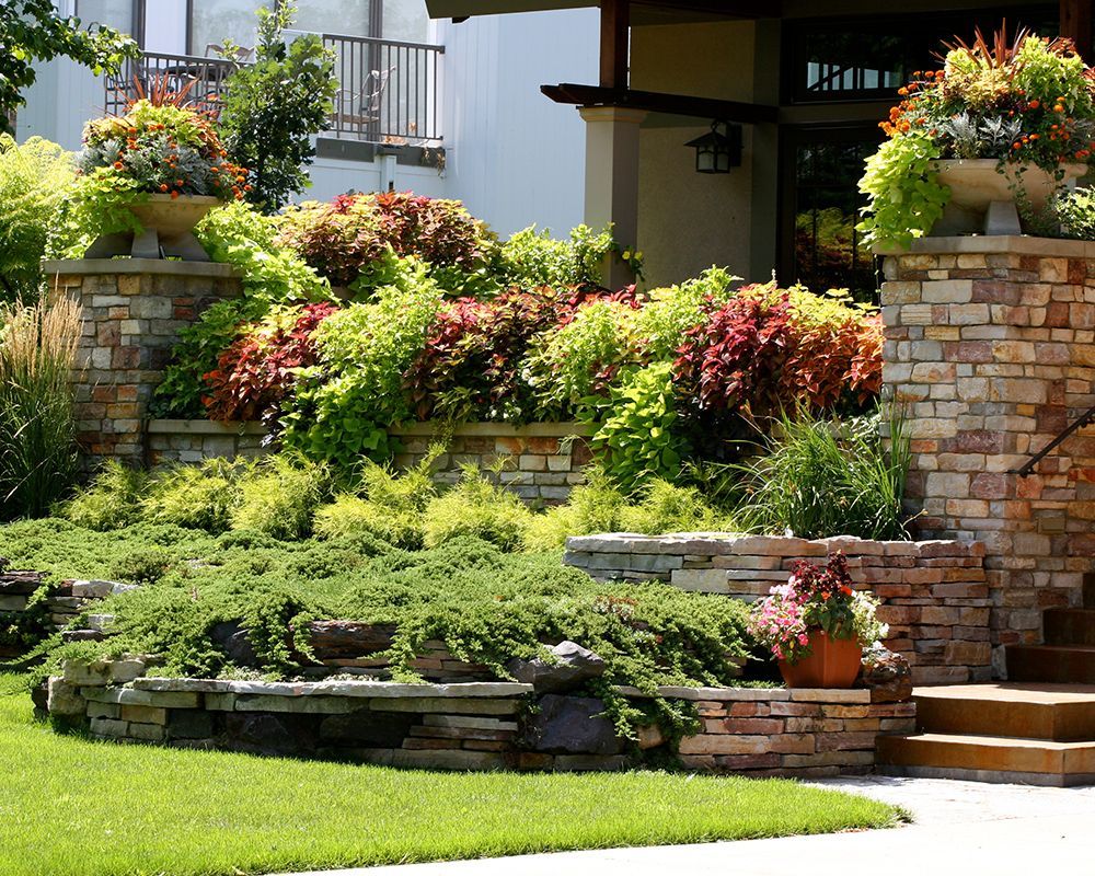 A large stone wall showcasing expert craftsmanship, highlighting Landscaping Services in Portage, MI