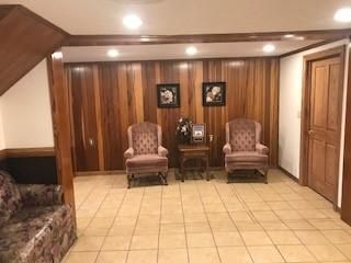 A living room with two chairs , a couch , and a table.