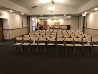 A large room with rows of chairs in it.