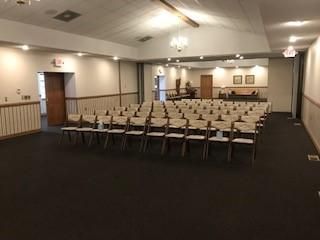A large room with rows of chairs in it.