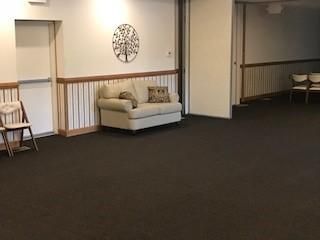 A living room with a couch and chairs in it.