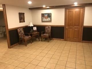 There are two chairs and a table in the room.