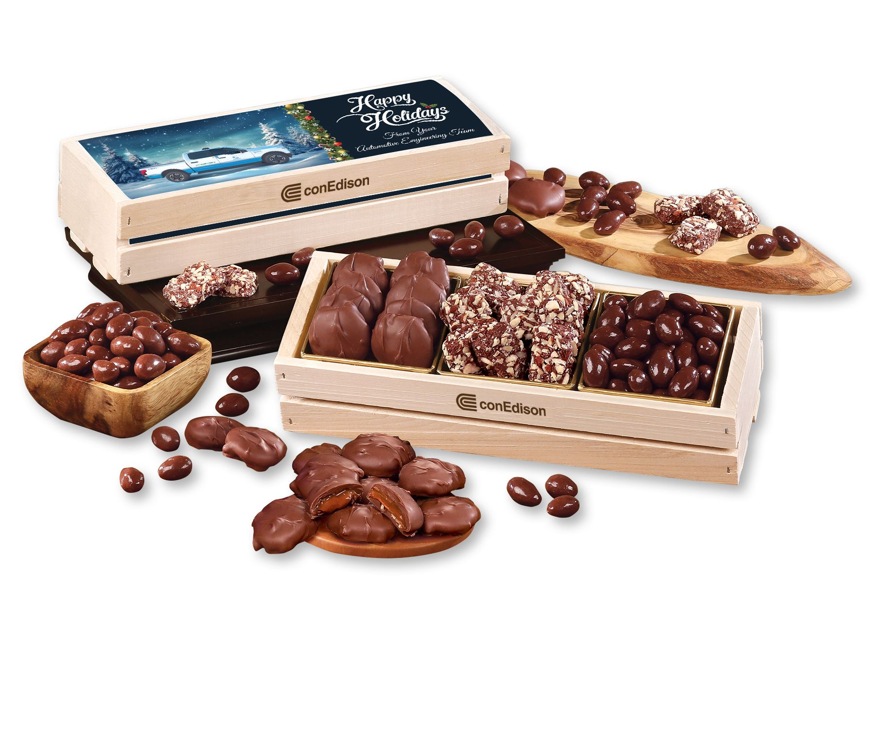 Assorted chocolates and truffles in open wooden gift boxes with scattered pieces on a white background