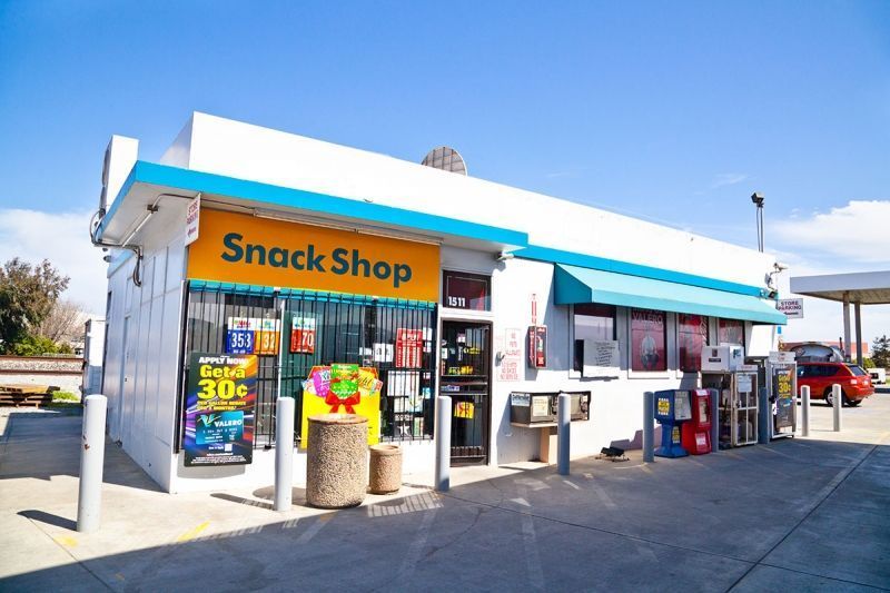 A gas station with a snack shop inside of it