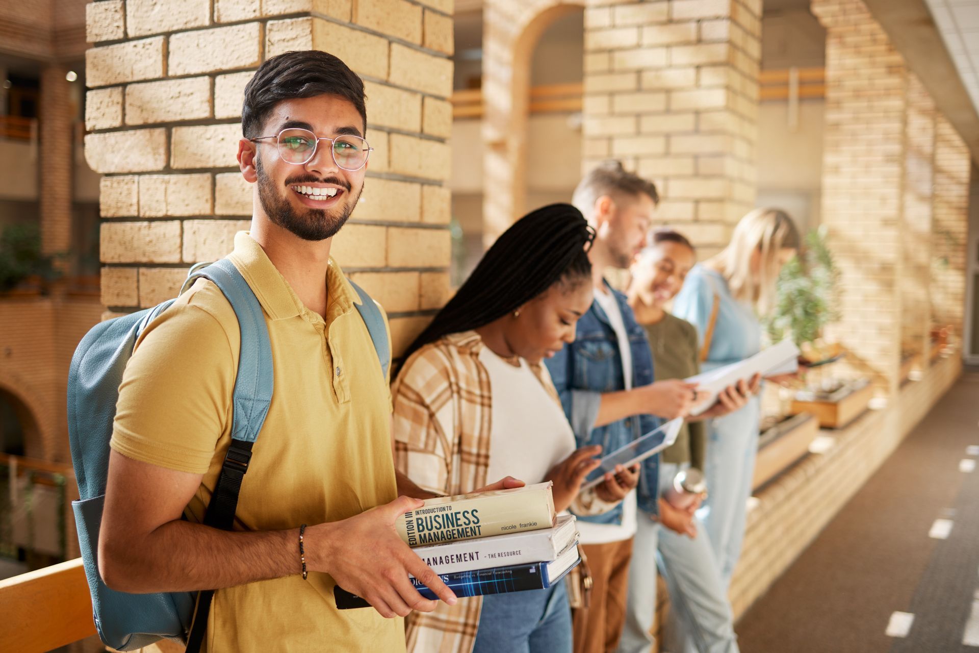 students standing in university hallway 