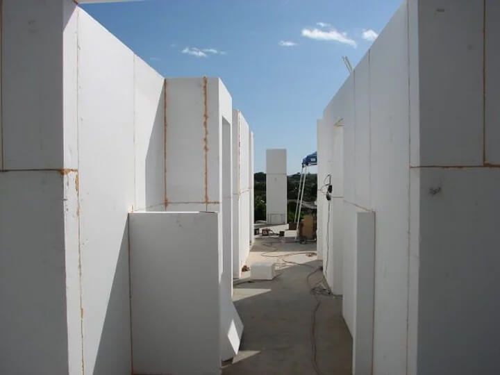A maze of white walls with a blue sky in the background.