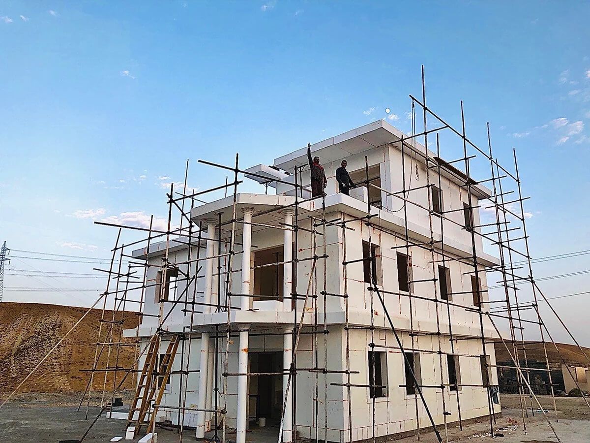A house is being built with scaffolding around it.