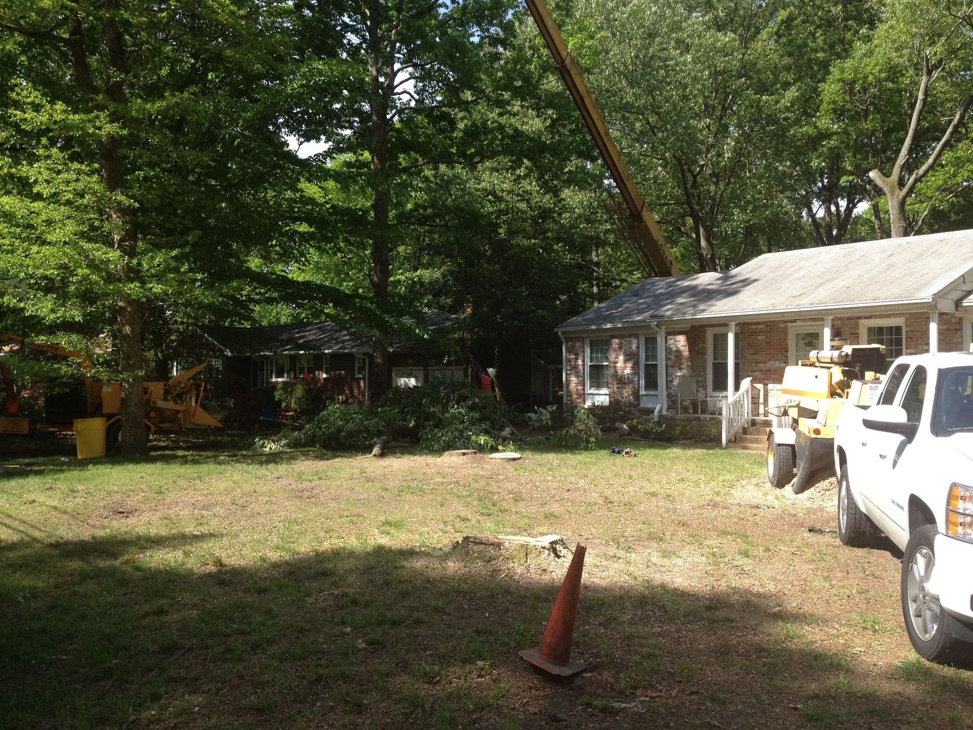 A white truck is parked in front of a house.