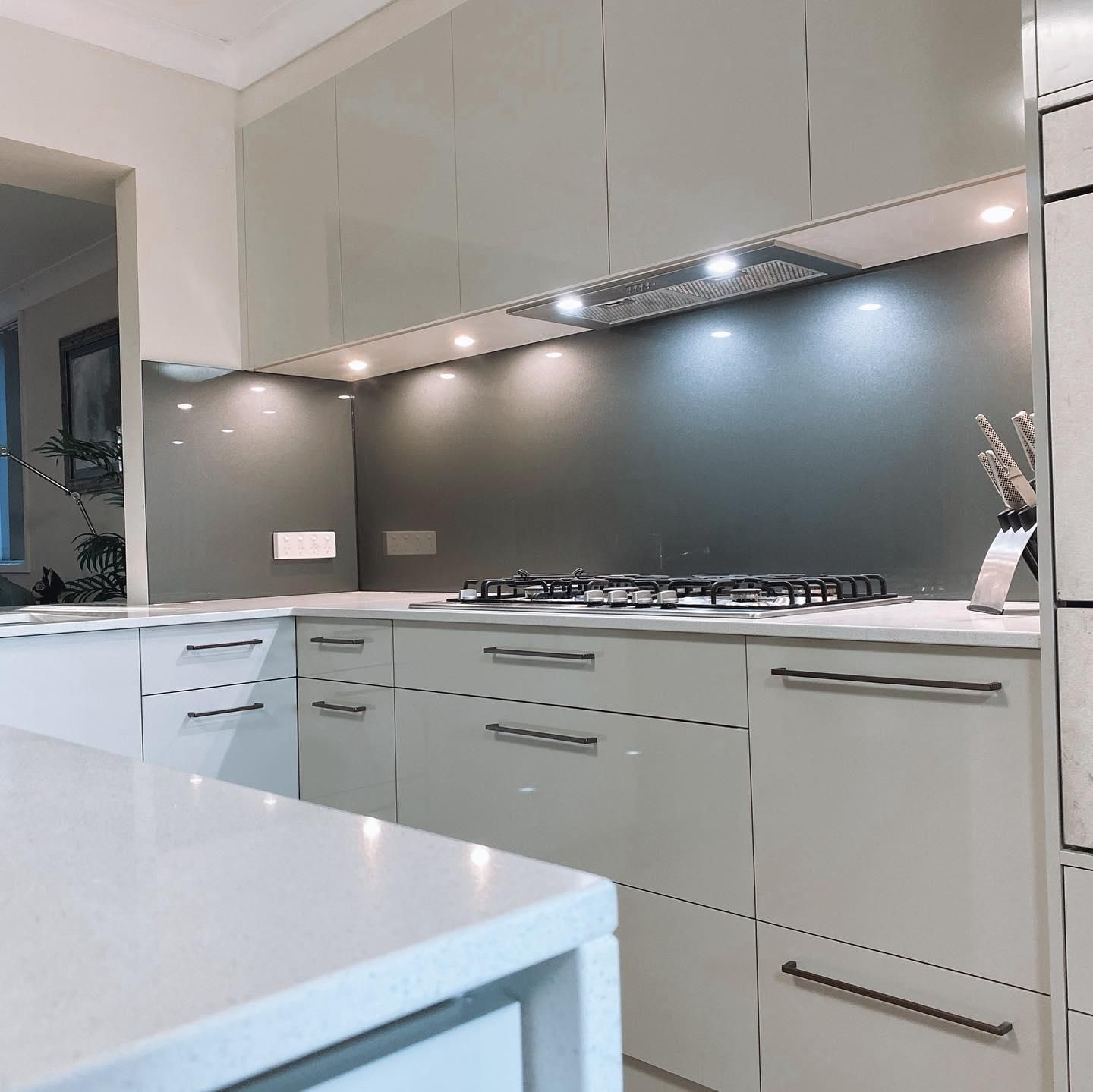 A Kitchen with White Cabinets and A Stove Top Oven — Distinctive Glass In Toormina, NSW