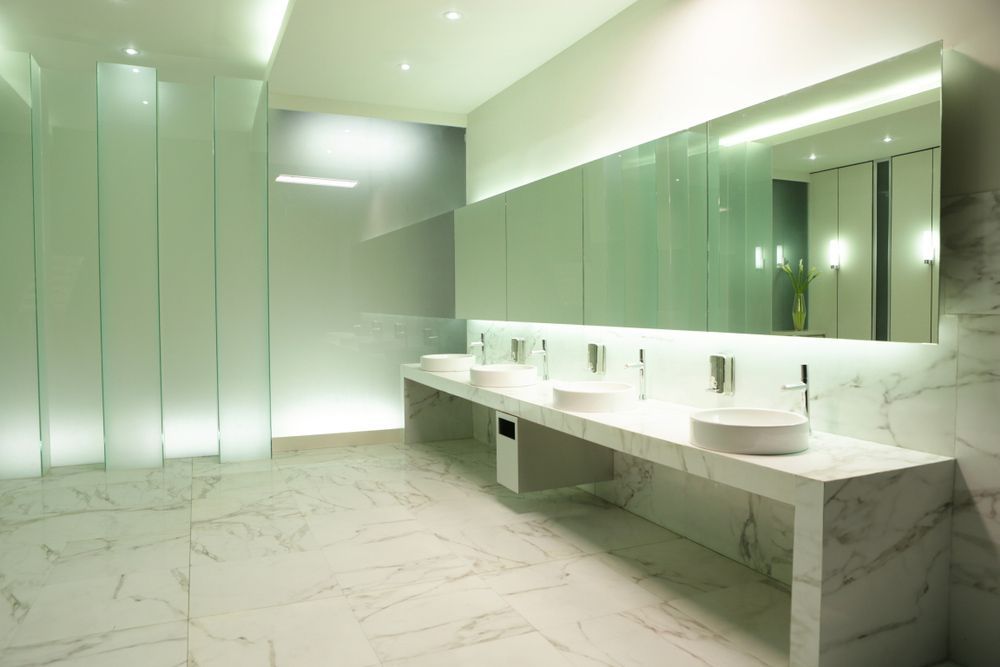 A Bathroom with A Row of Sinks and A Large Mirror — Distinctive Glass In Kempsey, NSW