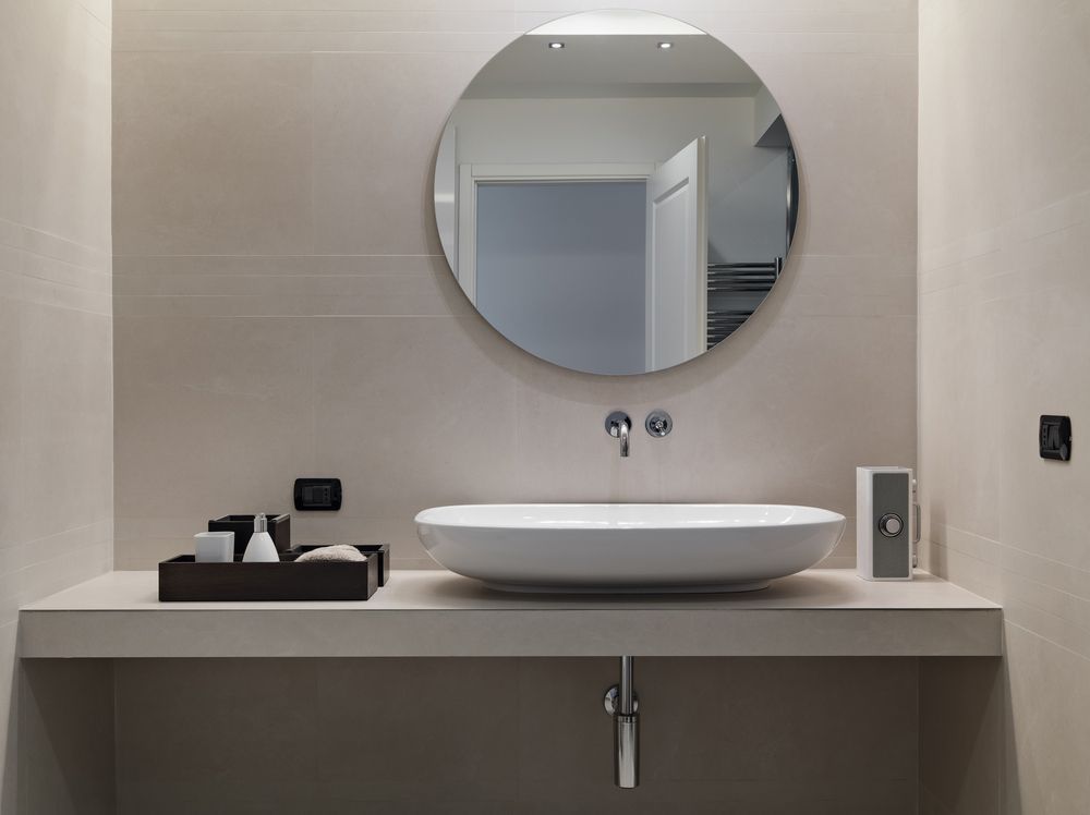 A Bathroom with A Sink and A Round Mirror — Distinctive Glass In Port Macquarie, NSW