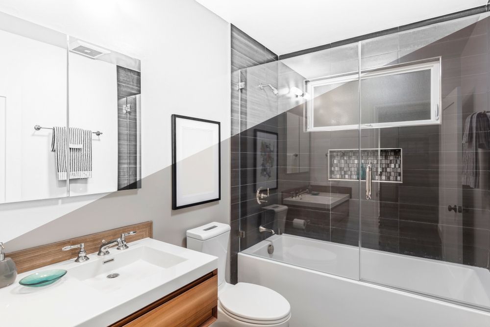 A Bathroom with A Toilet, Sink, and Bathtub — Distinctive Glass In Kempsey, NSW