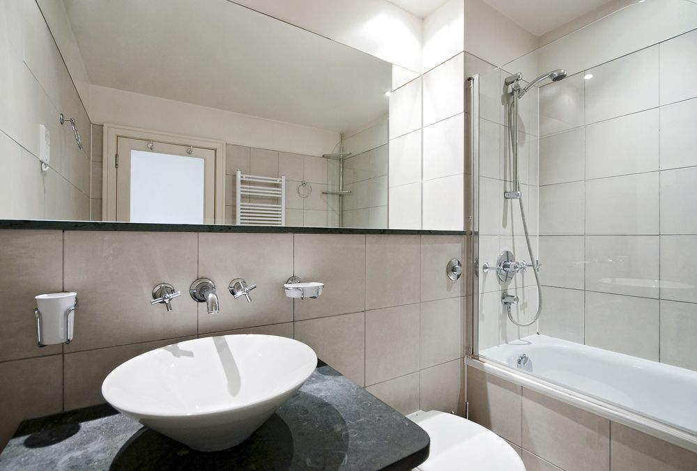 A Bathroom with A Sink a Toilet and A Bathtub — Distinctive Glass In Taree, NSW