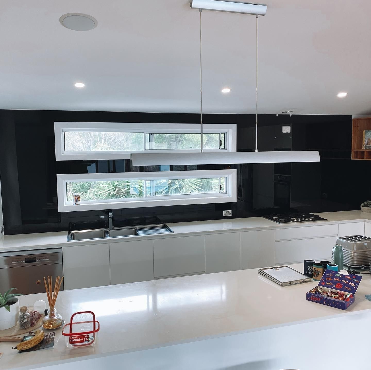 A Kitchen with White Cabinets and A Large Window — Distinctive Glass In Kempsey, NSW