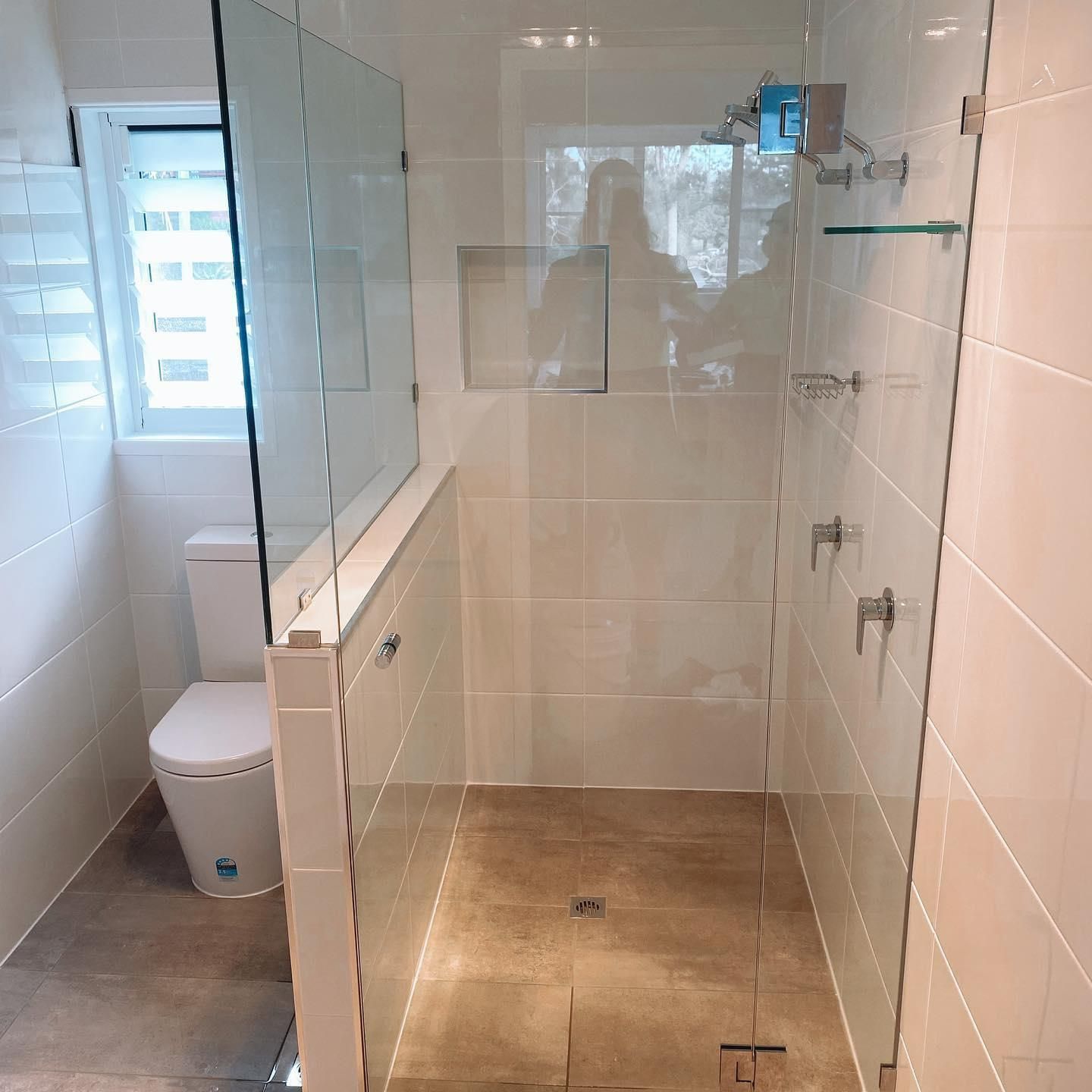 A Bathroom with A Toilet and A Walk in Shower — Distinctive Glass In Toormina, NSW