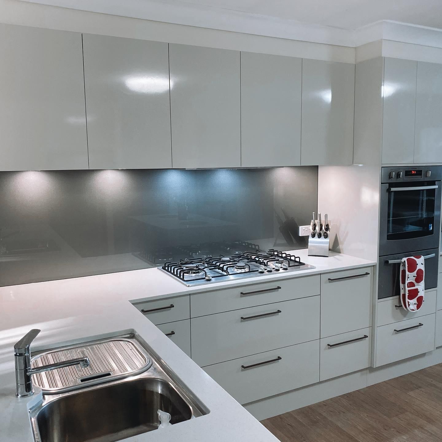A Kitchen with White Cabinets and A Stove Top Oven — Distinctive Glass In Toormina, NSW