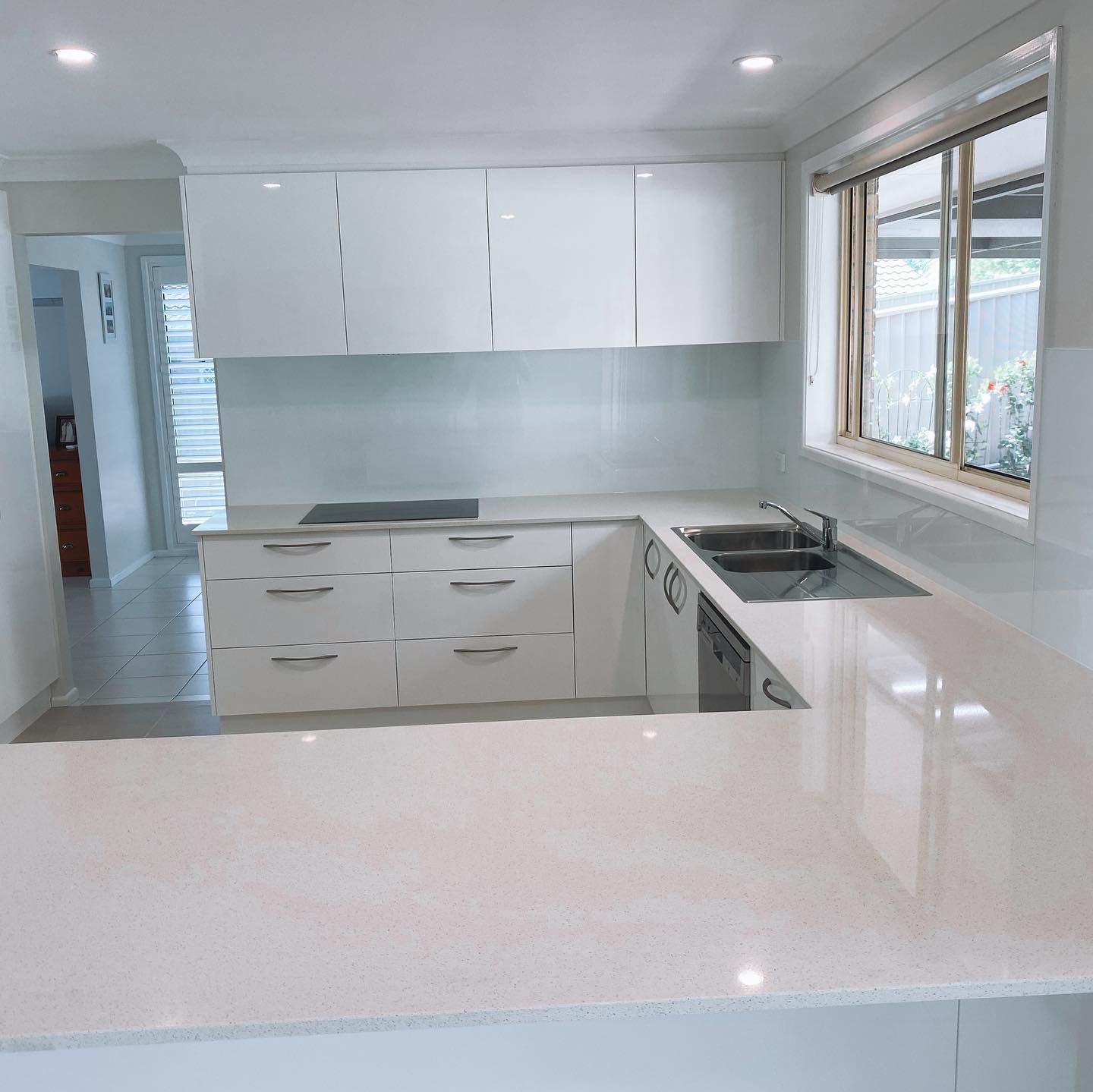 A Kitchen with A White Counter Top and A Blue Splashback — Distinctive Glass In Kempsey, NSW