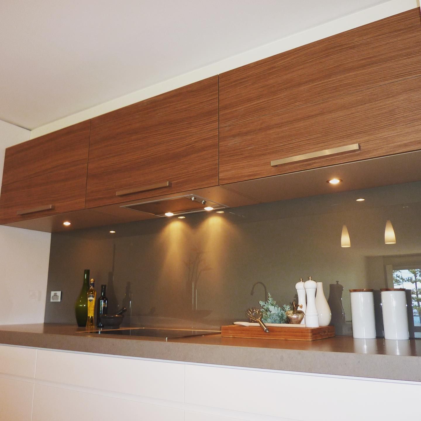 A Kitchen Counter With Cabinets And Splashback— Distinctive Glass In Toormina, NSW