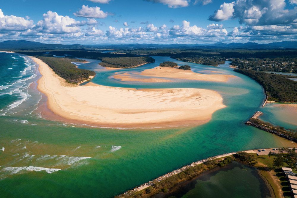 An Aerial View of A River with A Sandy Beach in The Middle of It — Distinctive Glass In Nambucca Heads, NSW