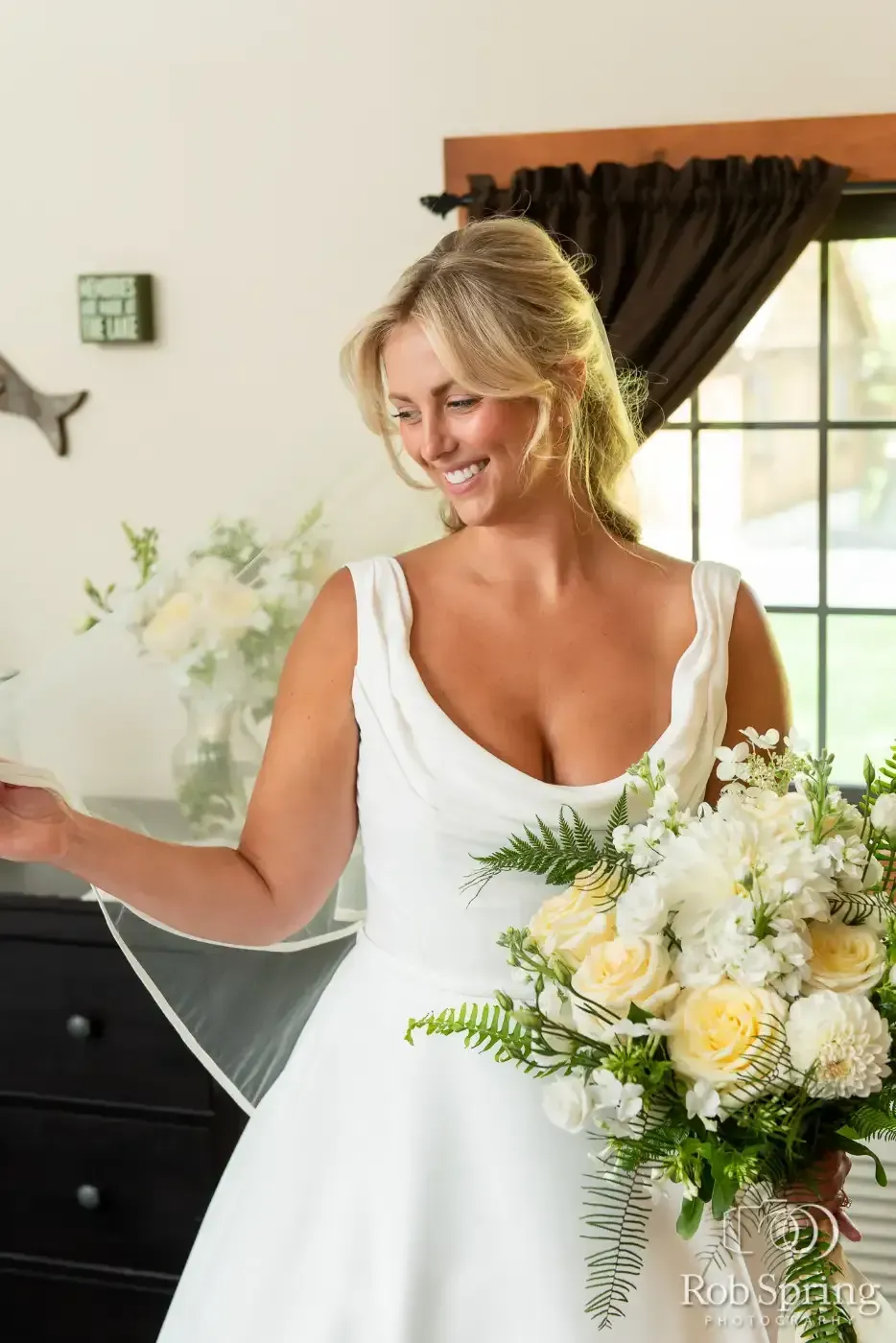 The bride is wearing a white dress and holding a bouquet of flowers.