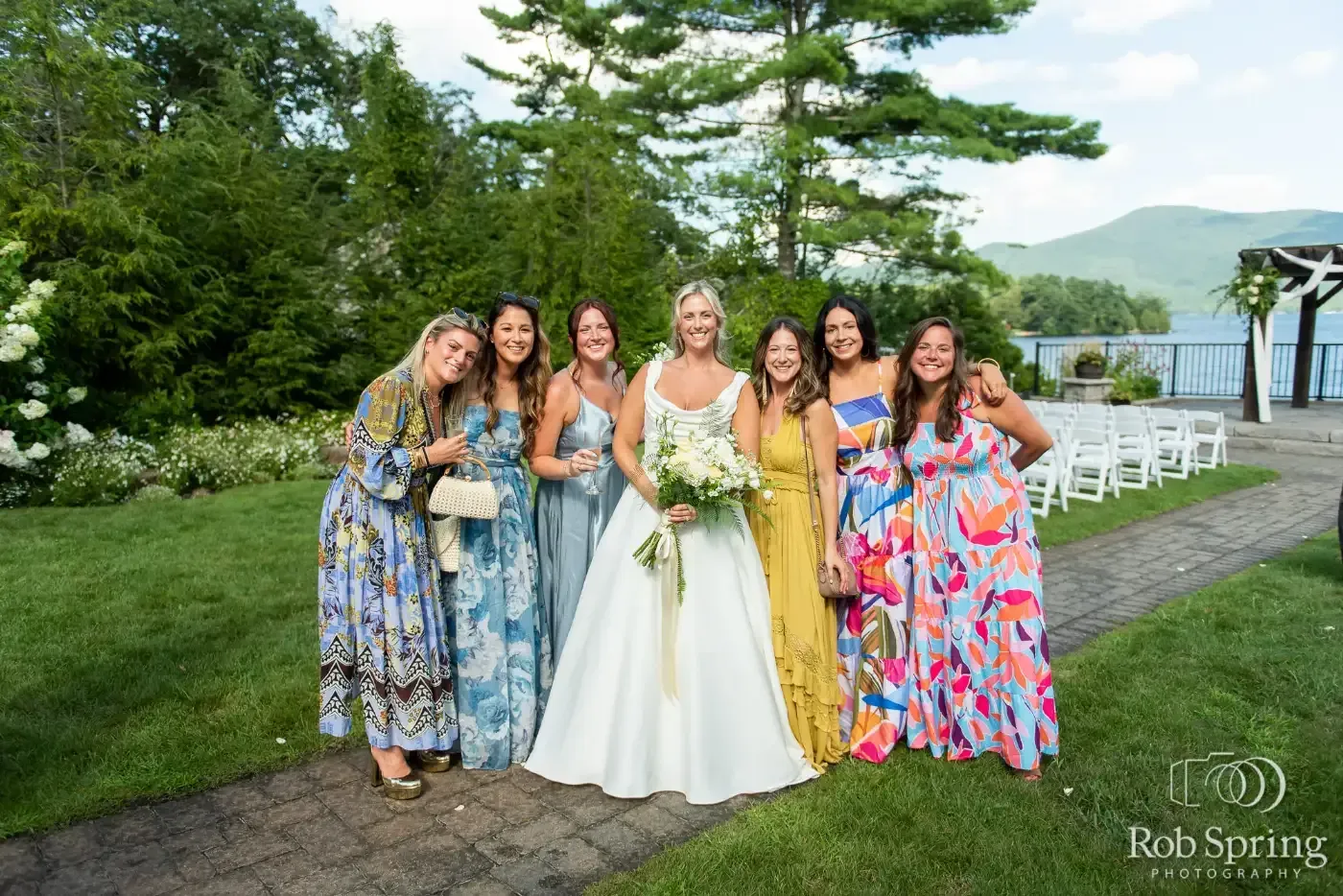 A bride and her bridesmaids are posing for a picture.