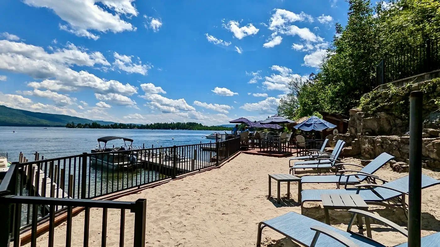 Lounge chairs and sandy area on the lake
