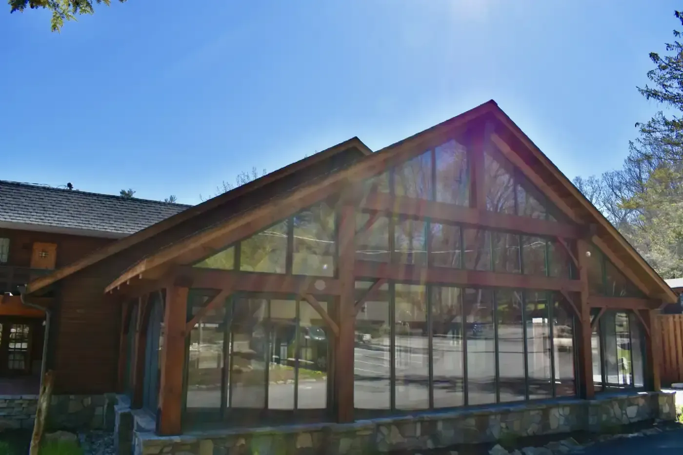 A large building with a lot of windows and a wooden roof