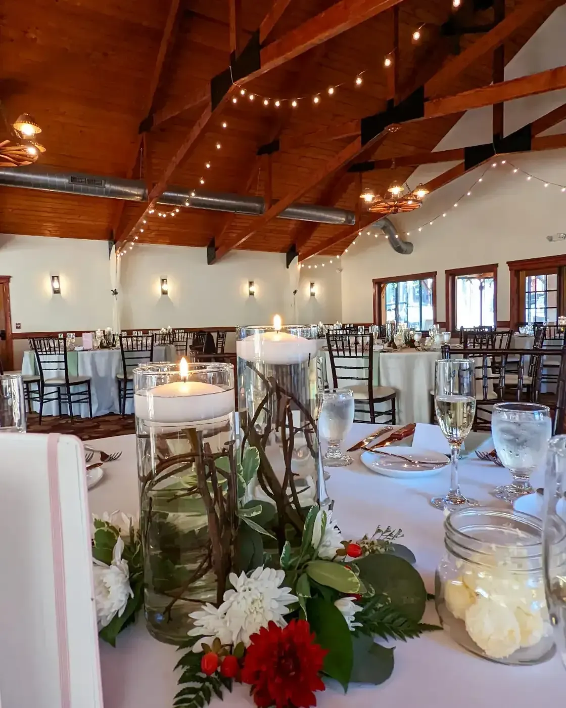 A table set for a wedding reception with candles and flowers