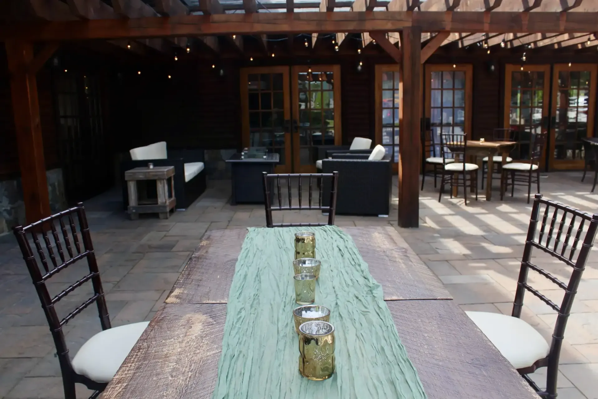 A patio with a table and chairs under a pergola
