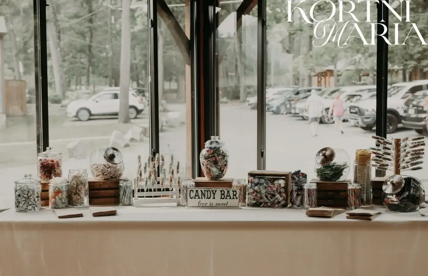 A candy bar is sitting on a table in front of a window.