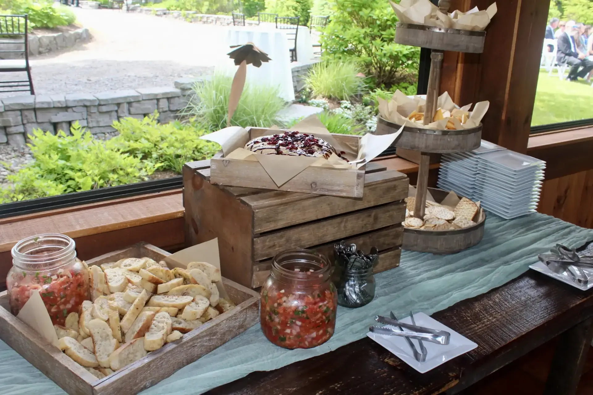 A table with a variety of food on it and a window in the background.