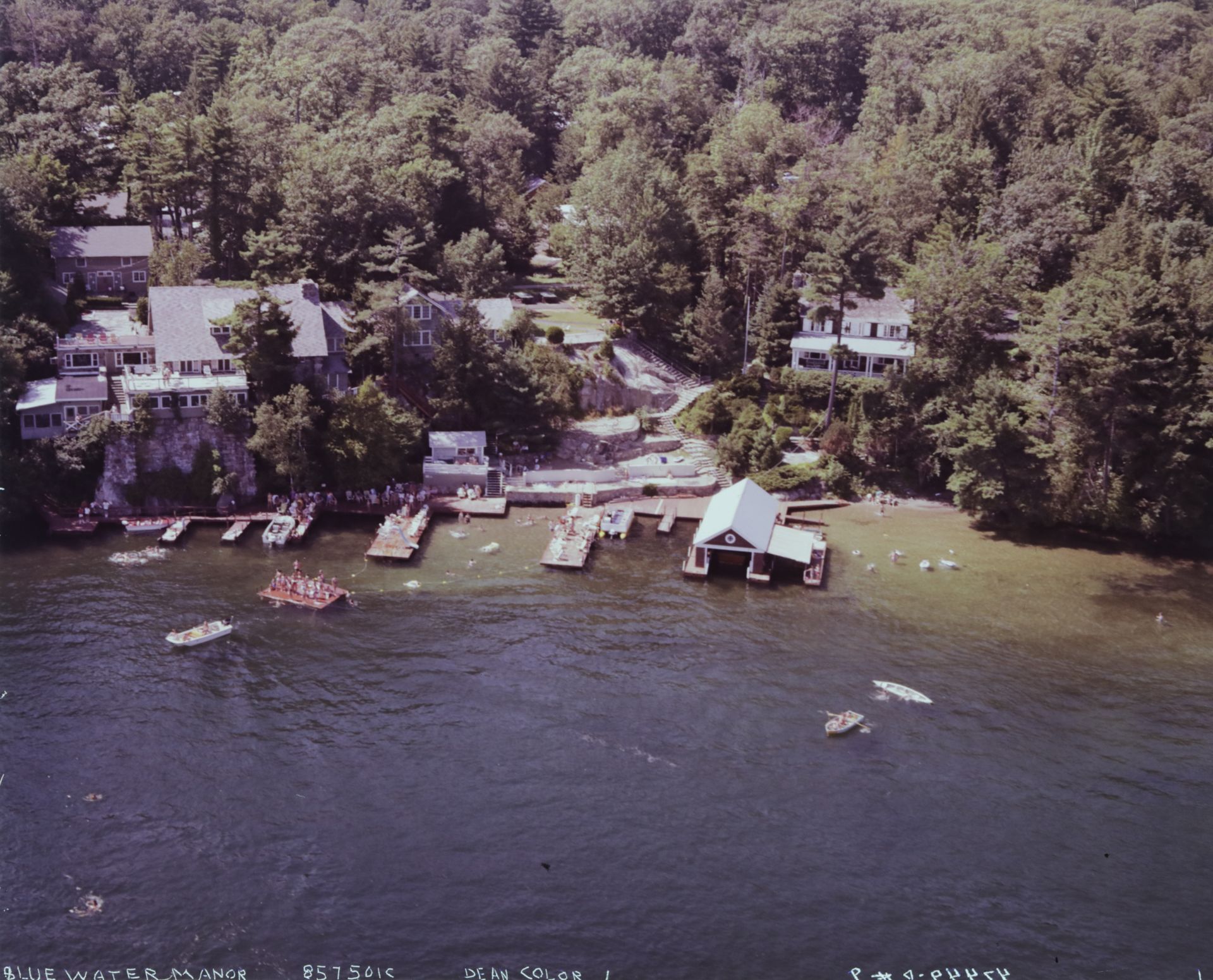 An aerial view of a lake with boats and houses