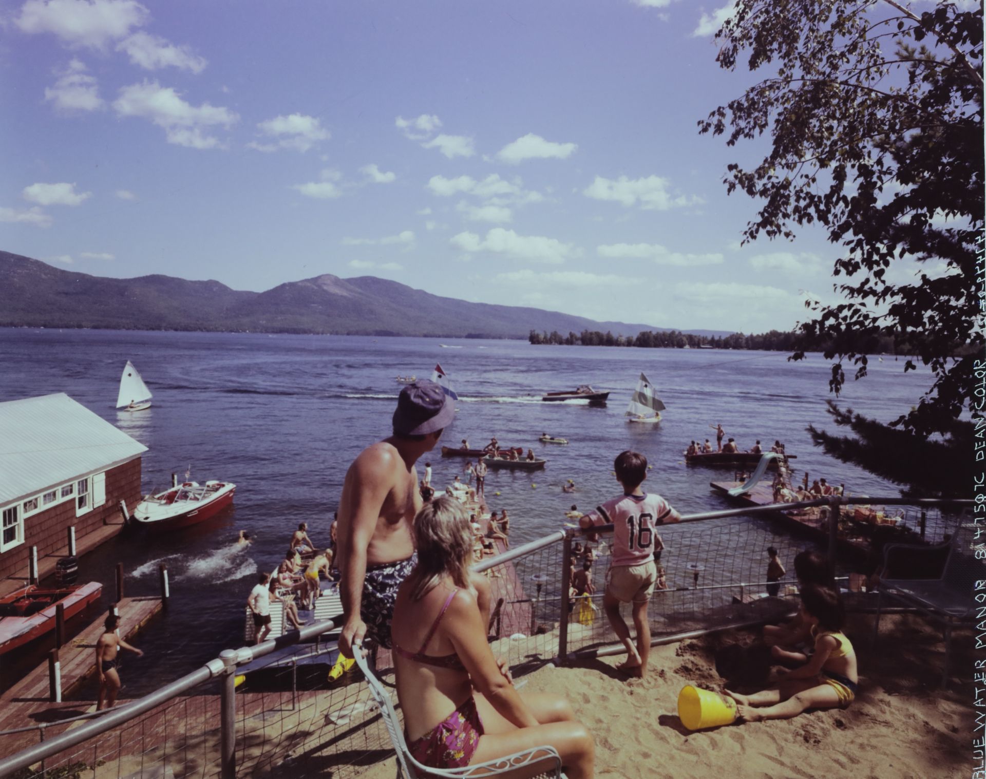 A man and a woman are looking out over a lake