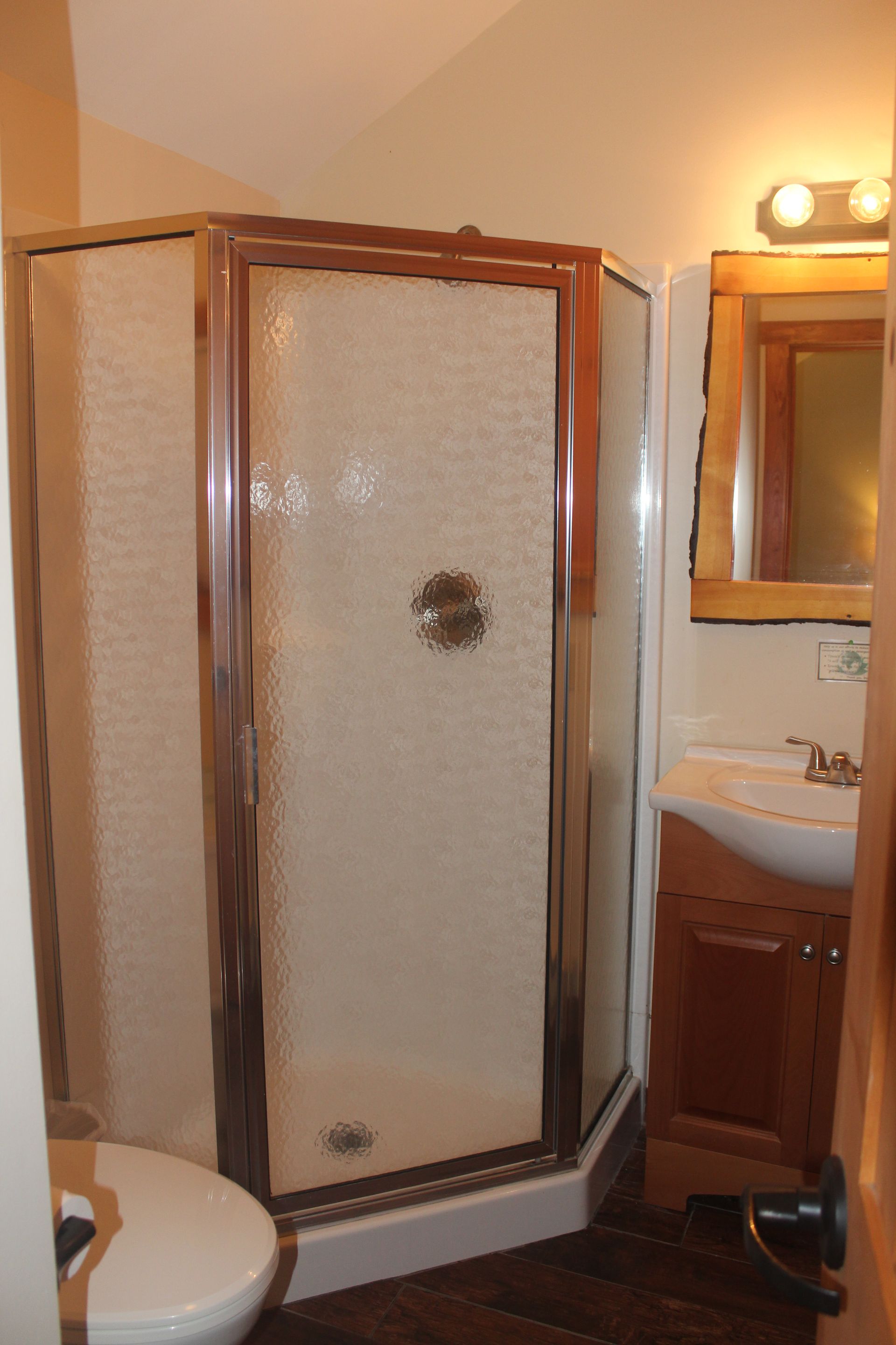 A bathroom with a toilet a sink and a shower
