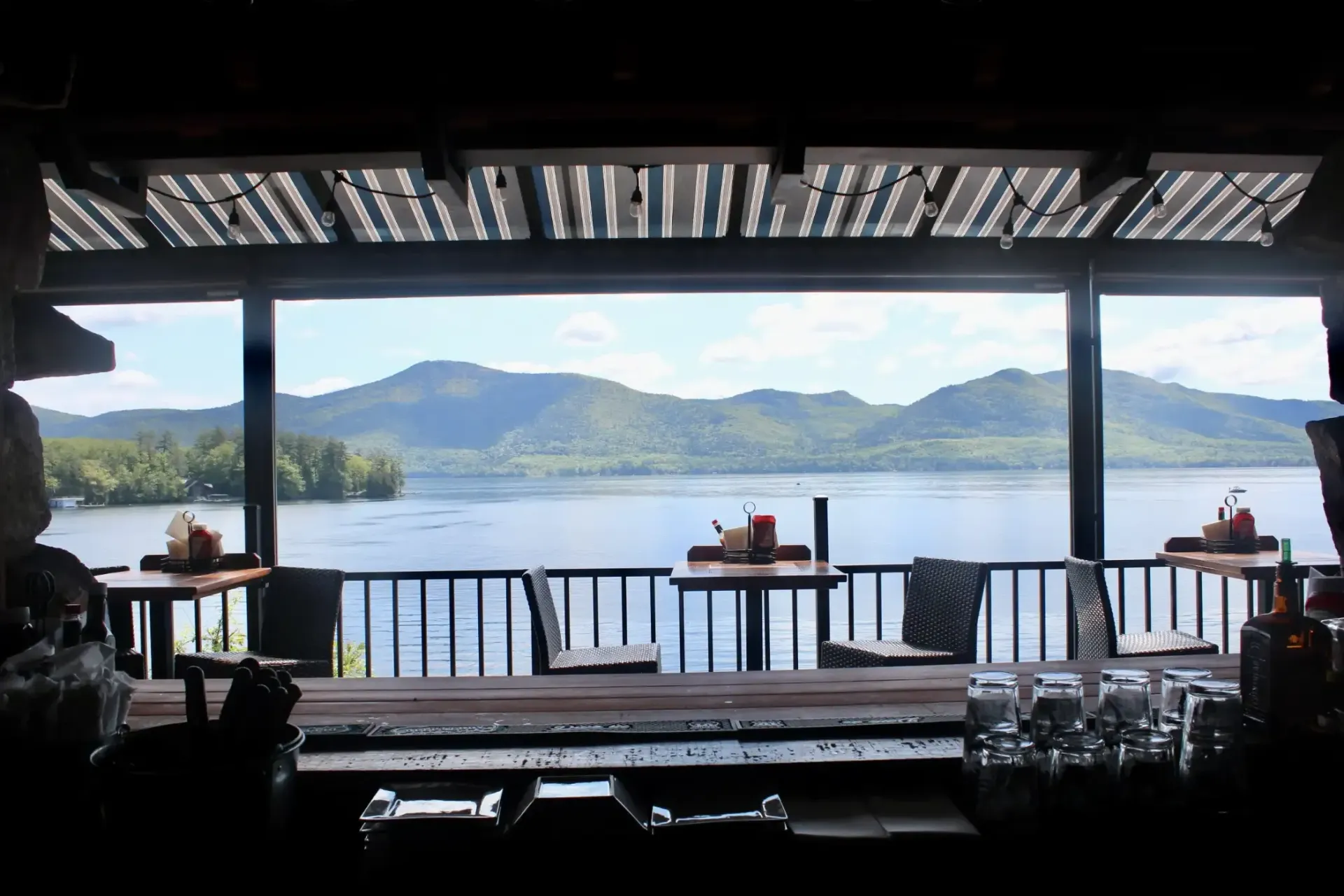 A bar with a view of a lake and mountains