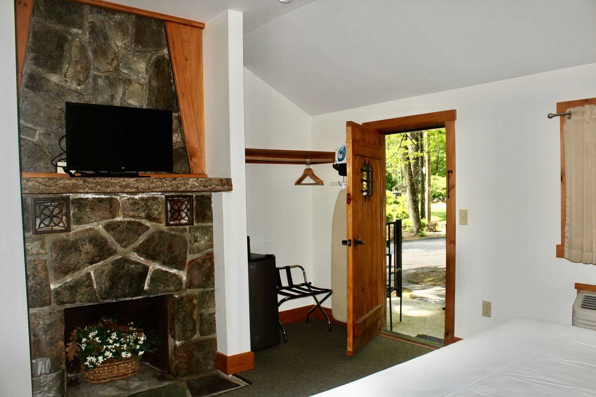 A bedroom with a fireplace and a flat screen tv