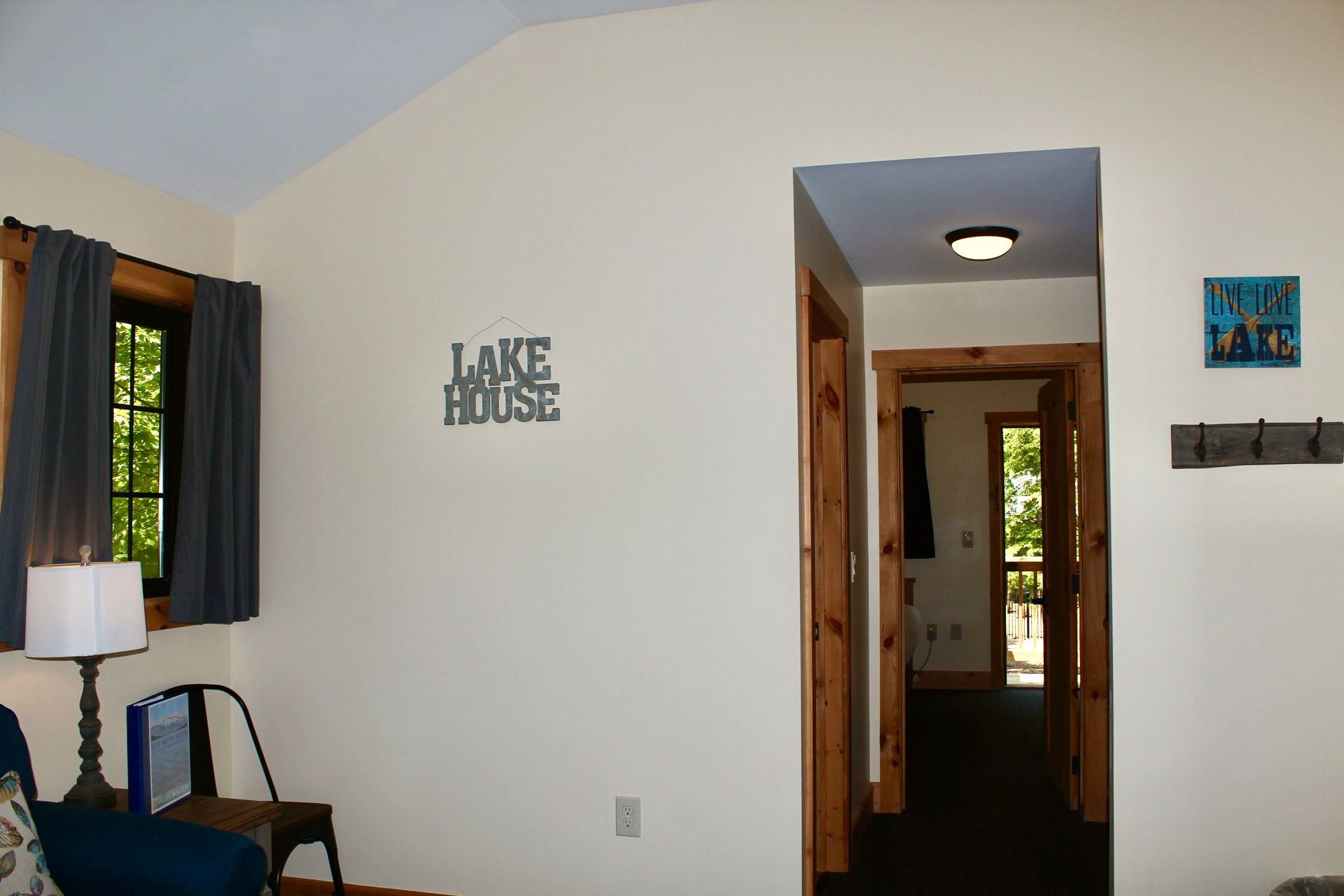 A room with a sign on the wall that says lake house