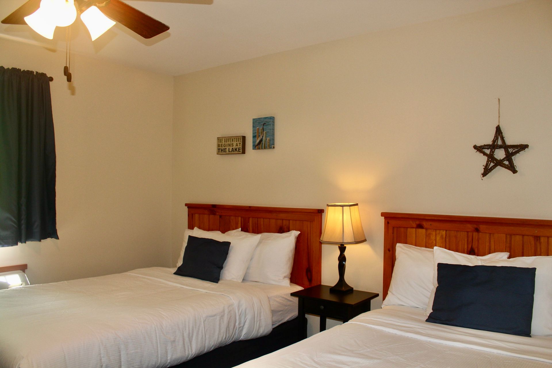 A bedroom with two beds and a star on the wall