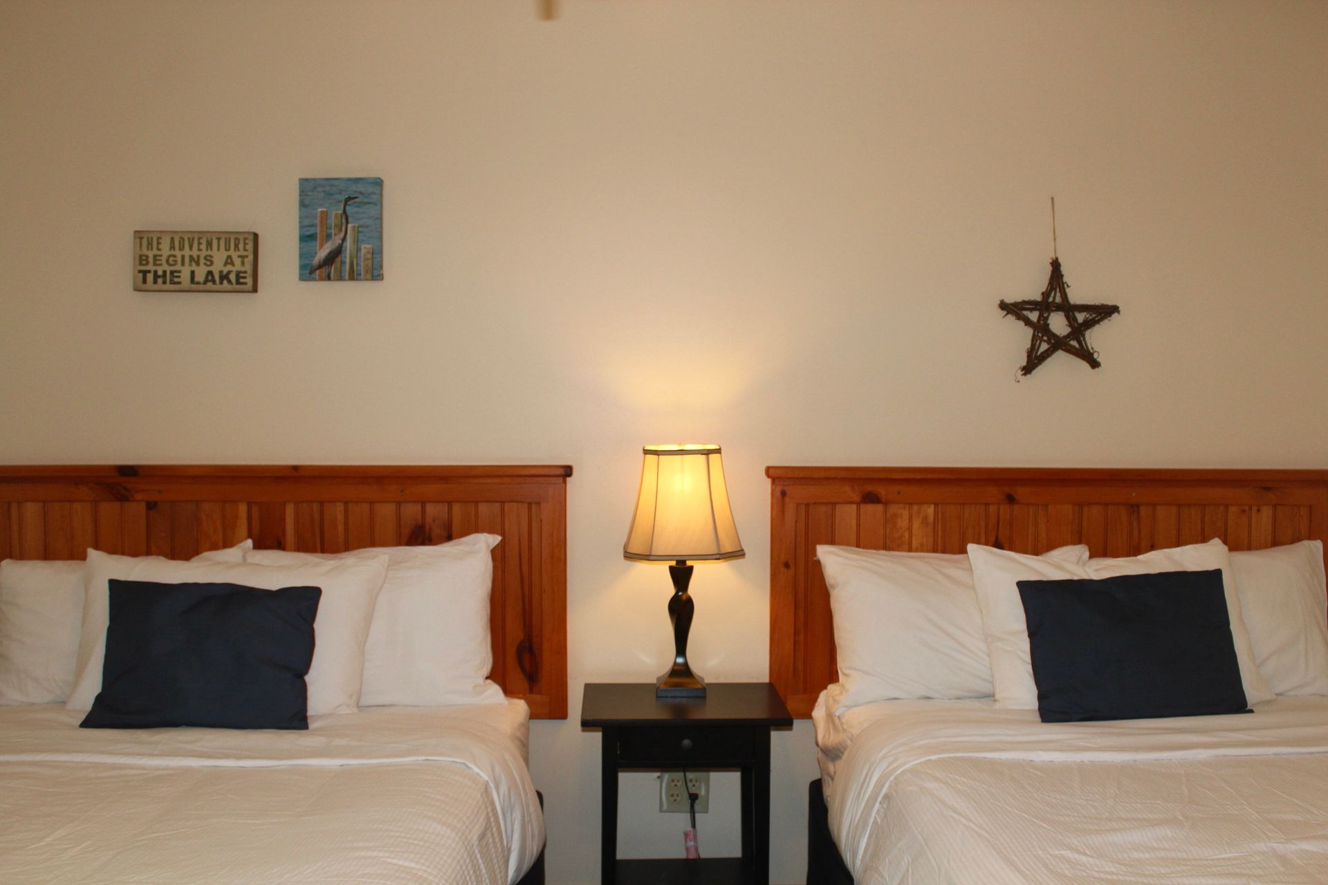 A bedroom with two beds and a star on the wall