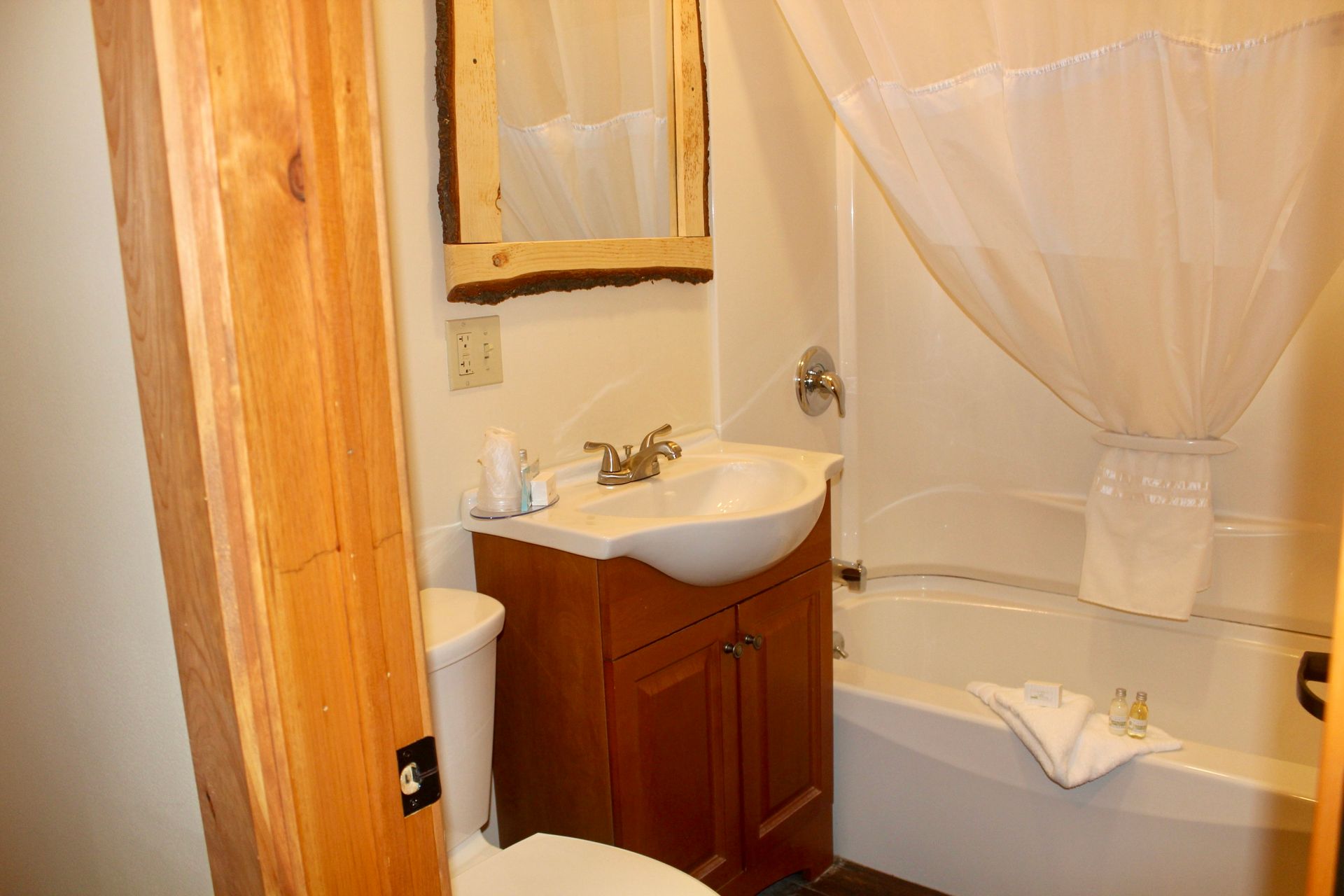 A bathroom with a toilet , sink , and bathtub.