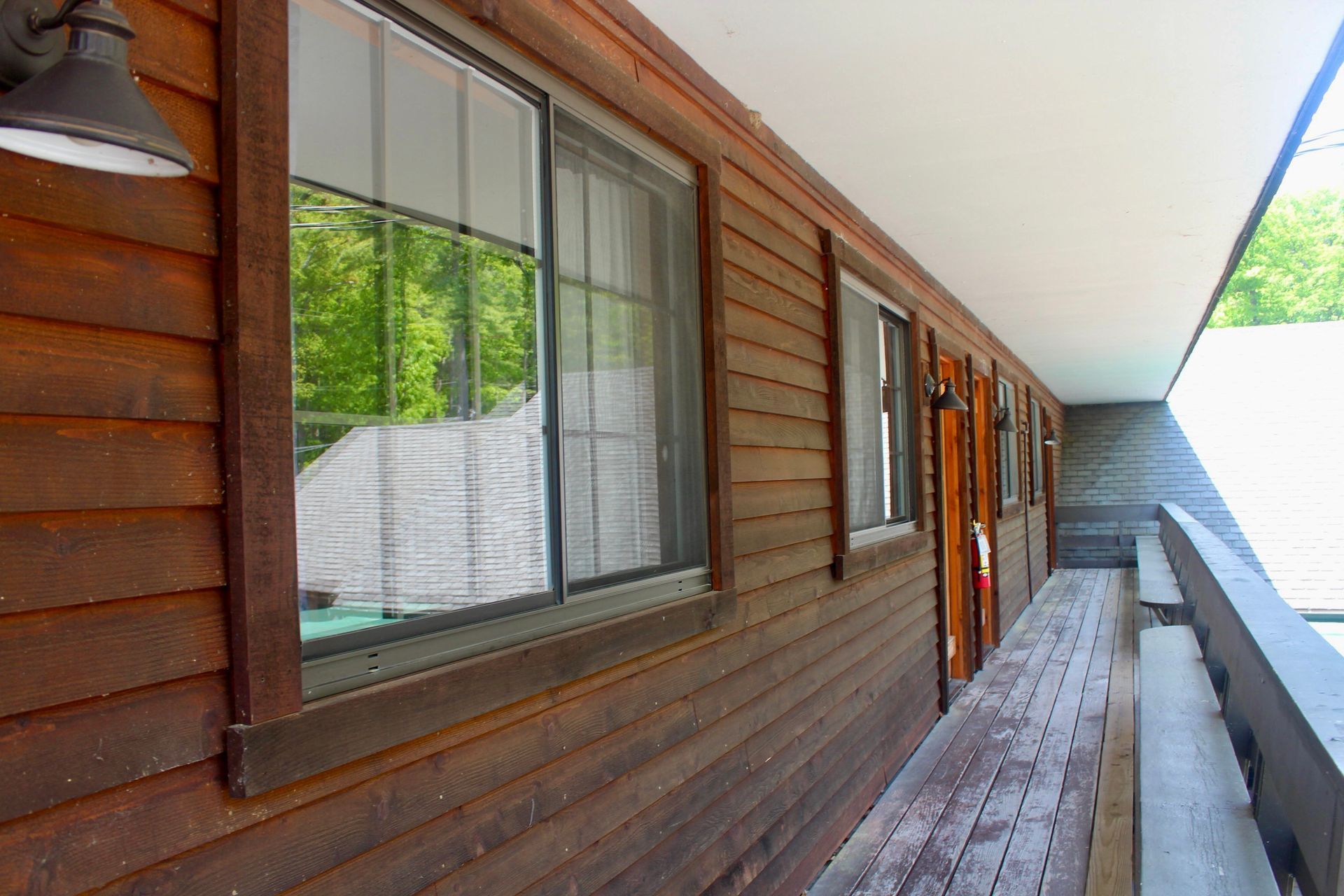 A wooden building with a balcony and a lot of windows