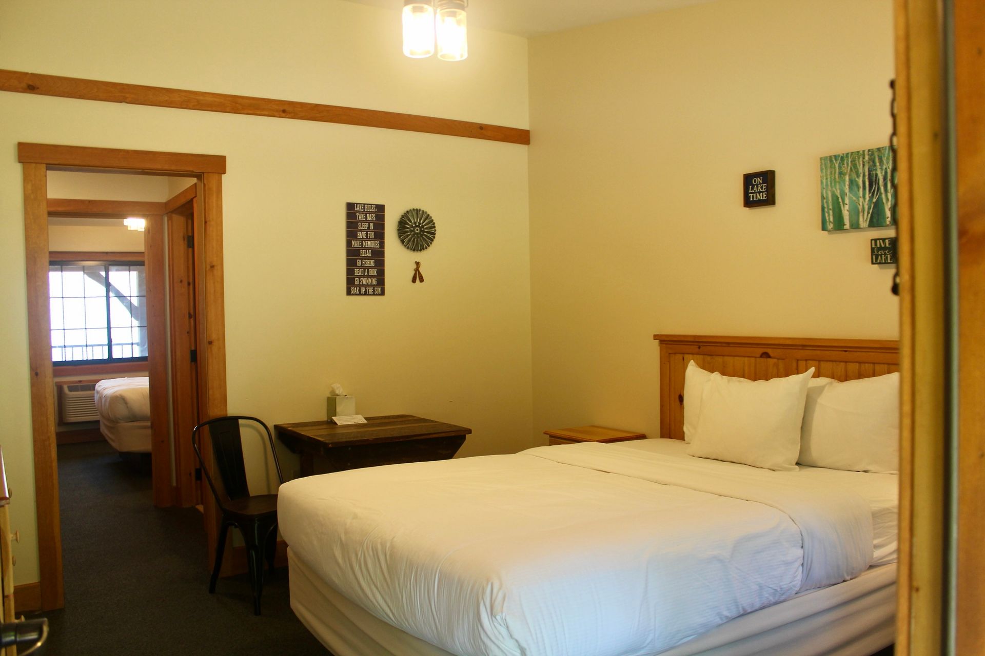 A hotel room with a king size bed and a desk