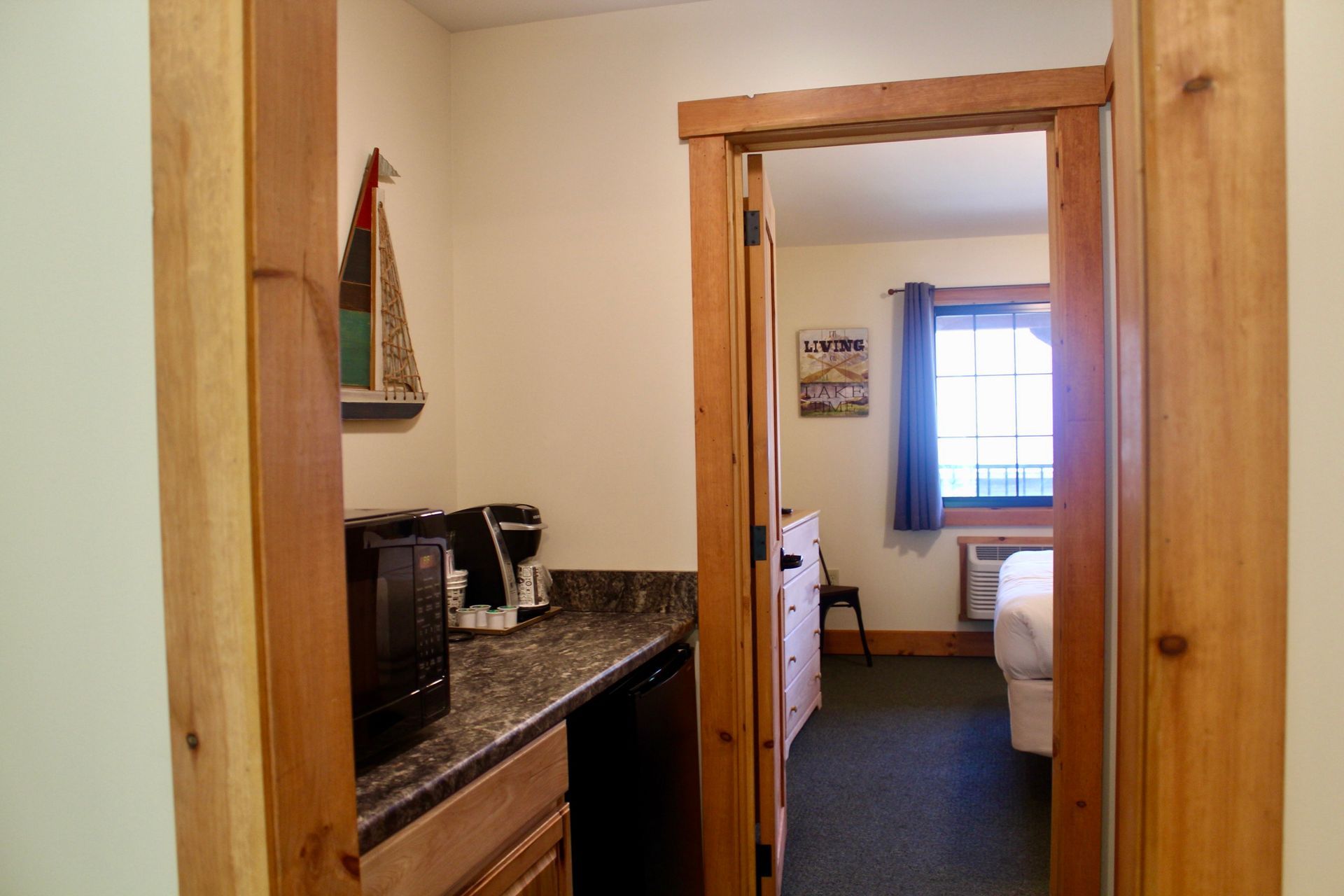 A hotel room with a microwave and a coffee maker