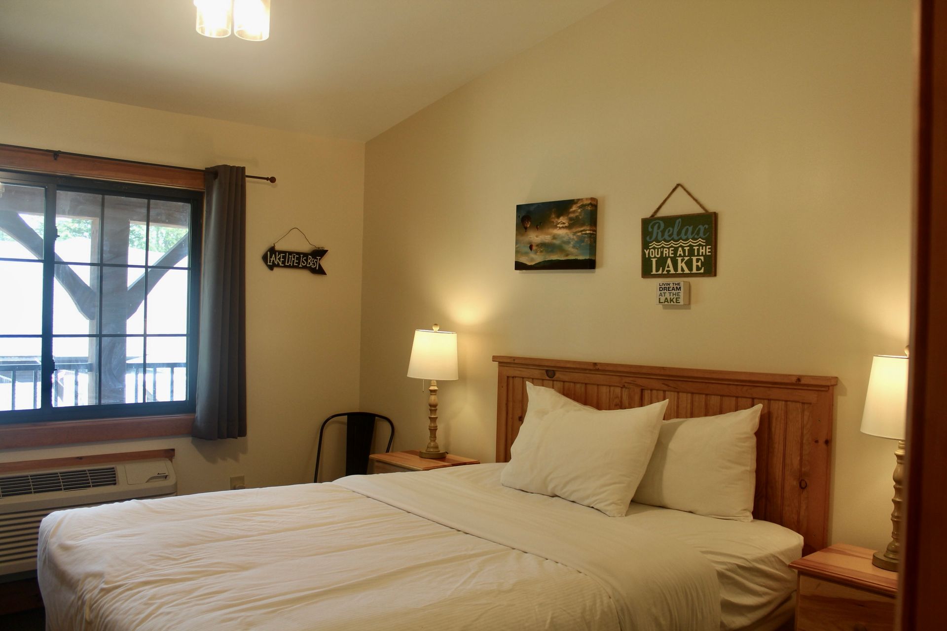 A bedroom with a king size bed and a window.