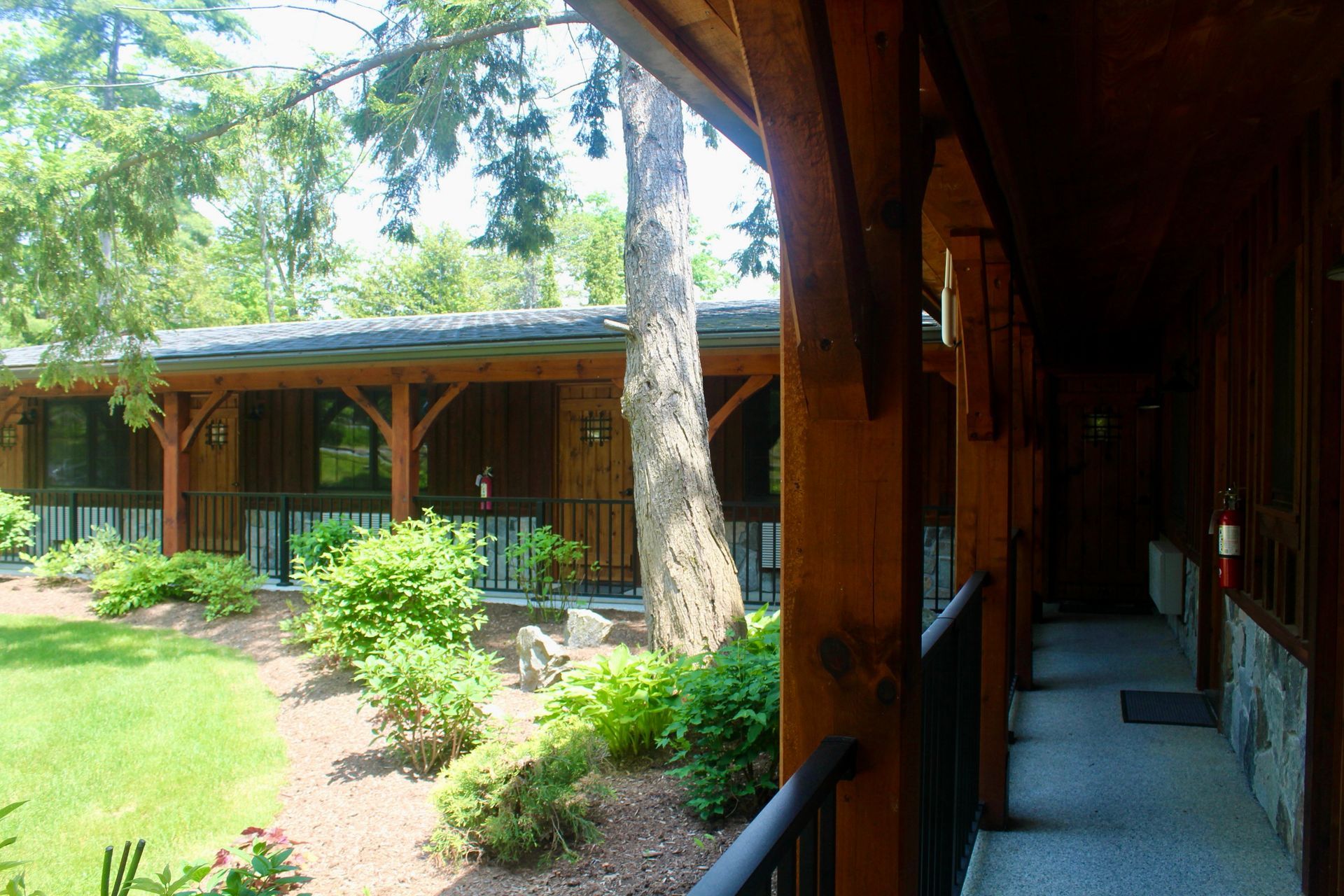 A wooden building with a covered walkway leading to it