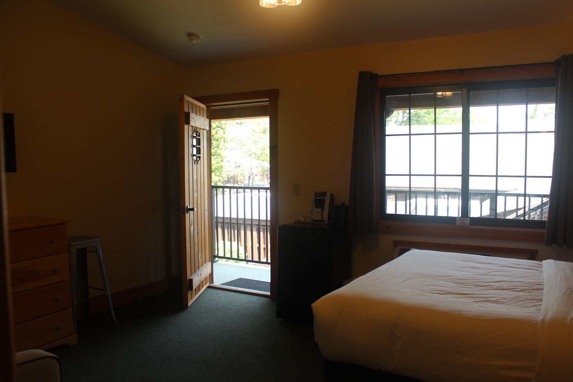 A hotel room with a bed and a balcony